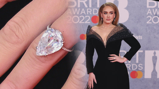 Adele wearing a large pear-shaped diamond ring on her left hand at the 2022 BRIT Awards, sparking engagement rumors and setting jewelry trends.