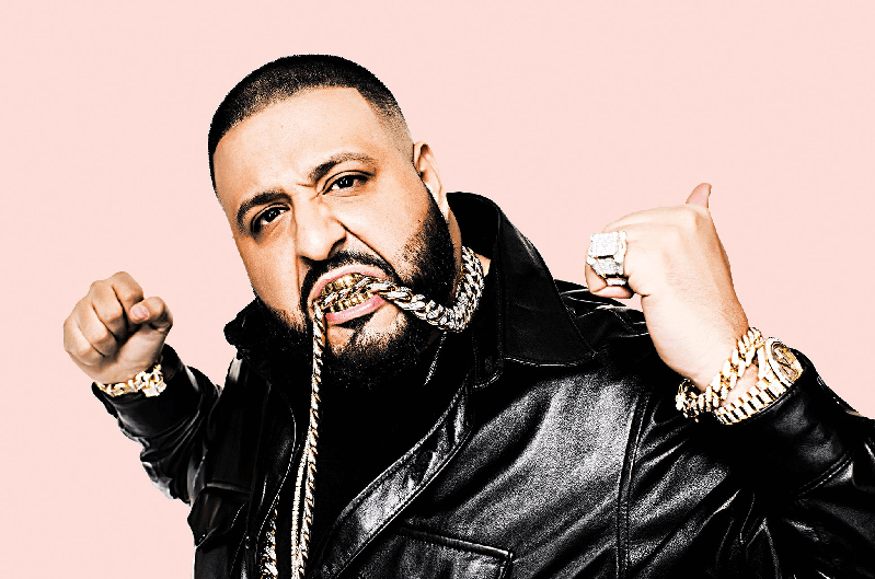DJ Khaled wearing a custom diamond lion pendant with 18k gold and a bustdown Rolex Sky-Dweller, showcasing hip-hop jewelry and iced-out statement style.