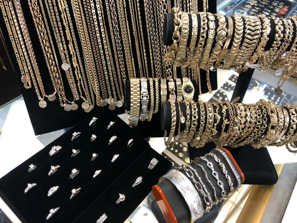 Close-up of a diamond ring and gold chain on a pawn shop counter, symbolizing secondhand jewelry resale value and hidden treasures.