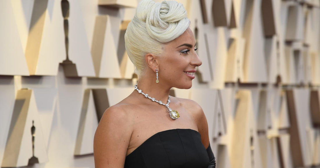 Lady Gaga wearing the 128-carat Tiffany Diamond at the Oscars, highlighting celebrity influence on luxury jewelry trends and red carpet style.