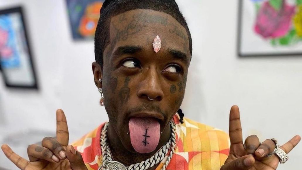 Lil Uzi Vert wearing a custom pendant featuring his $24 million pink GIA diamond originally implanted in his forehead, reset in rose gold with micro pavé detailing.