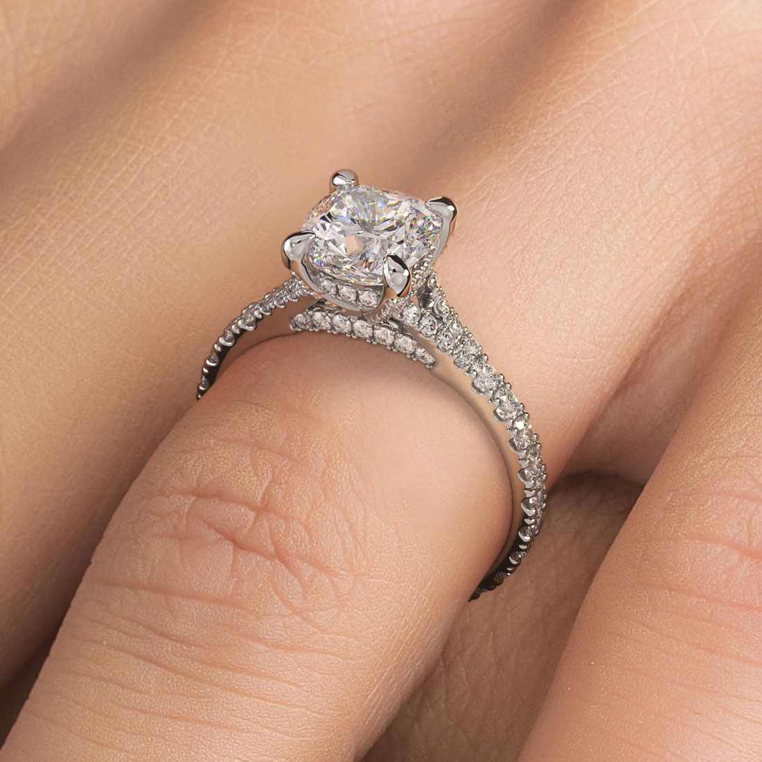 Cushion Cut Diamond Engagement Ring Setting in 18k white gold worn on finger, showcasing cathedral split shank design and dazzling 0.60ctw micropavé side stones (G color, SI1 clarity). Designed to hold a 1.50ct cushion center stone. A handcrafted masterpiece from Global Sky Diamonds, located in Manhattan’s Diamond District at 44W 47th St Booth GF-10. Discover timeless engagement rings at globalskydiamond.com
