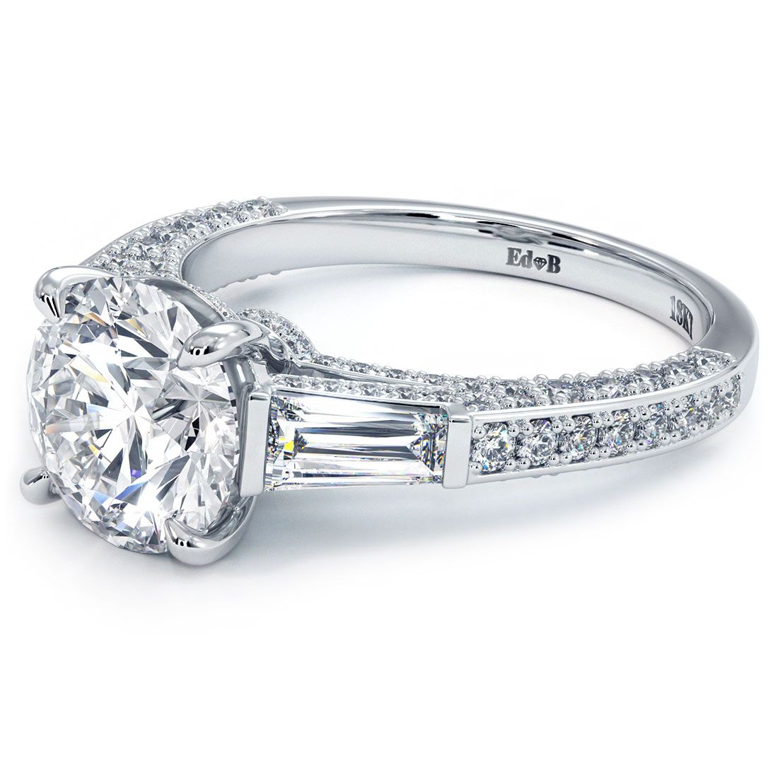 Angled view of diamond engagement ring setting with round center, tapered baguette sides, and pave diamond shank in 18k white gold from Global Sky Diamonds, Diamond District NYC, Booth GF-10, visit globalskydiamond.com