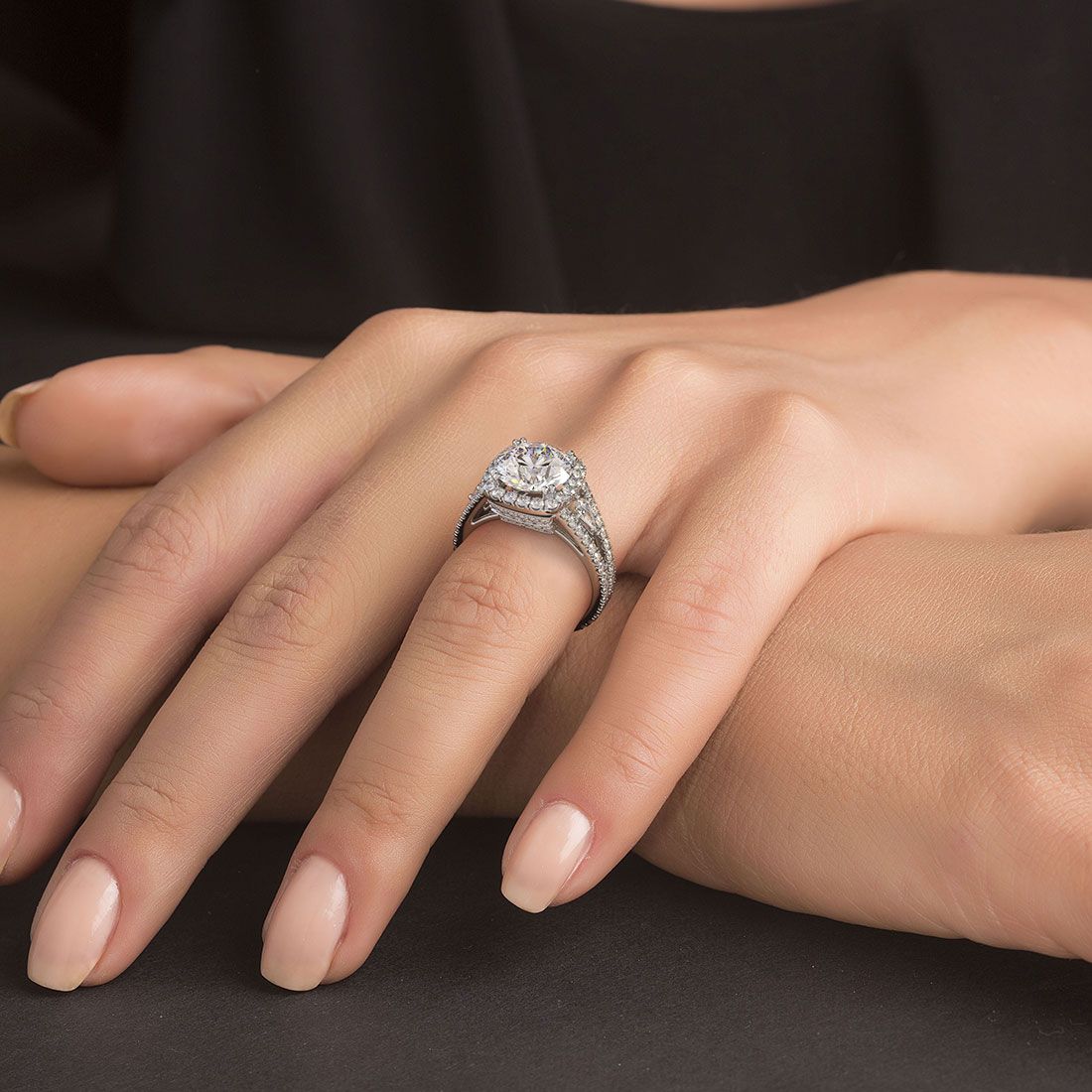 Lifestyle photo of cushion halo split shank engagement ring on hand, showcasing brilliance of round center diamond (2.50ct not included) and micropavé setting with 1.40ctw G color SI1 clarity side stones in 18k white gold — handcrafted at Global Sky Diamond, 44W 47th St Booth GF-10, Diamond District NYC, shop online at globalskydiamond.com.