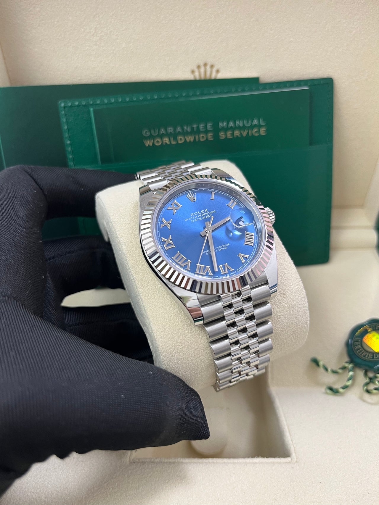 Angled image of Rolex Datejust 126334 with fluted bezel and blue Roman dial – pre-owned 2025 Rolex in mint condition with full set – available now at globalskydiamond.com – Diamond District NYC