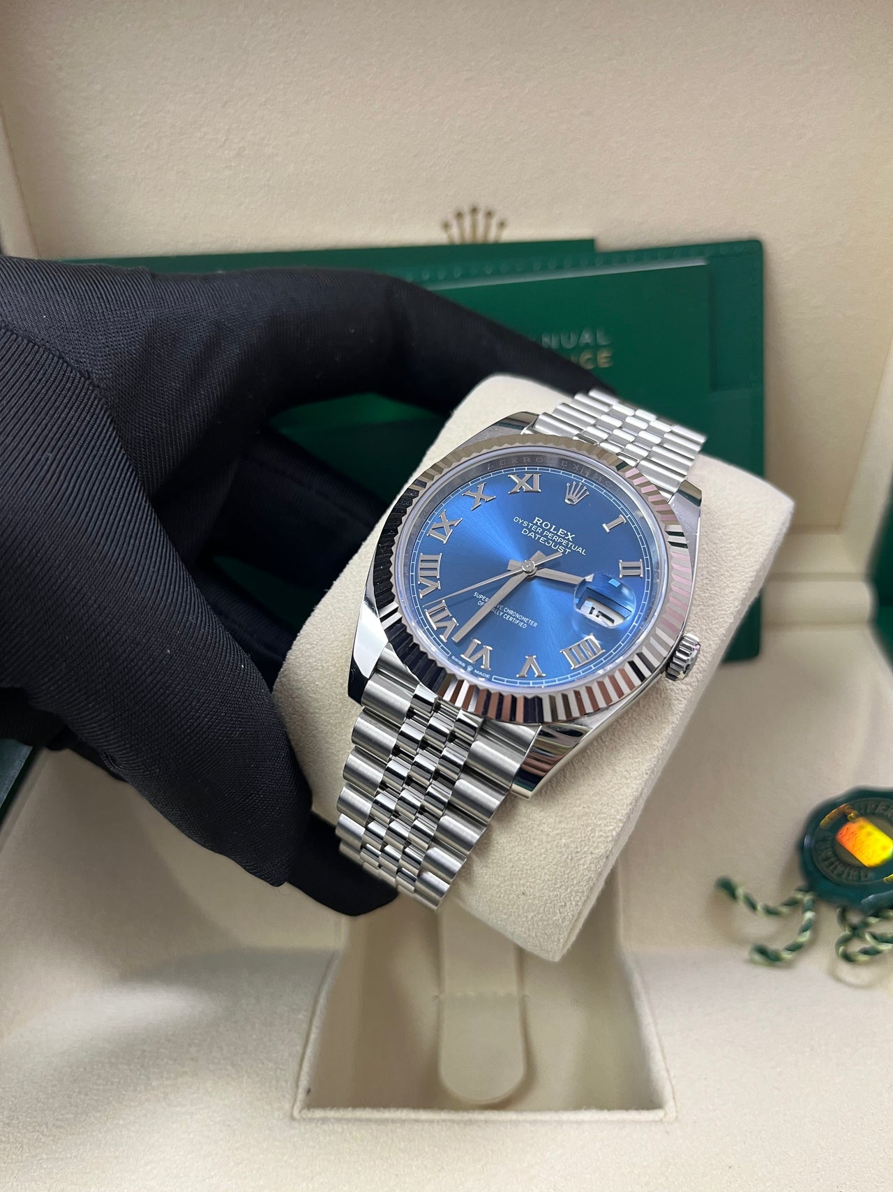 Angled image of Rolex Datejust 126334 with fluted bezel and blue Roman dial – pre-owned 2025 Rolex in mint condition with full set – available now at globalskydiamond.com – Diamond District NYC