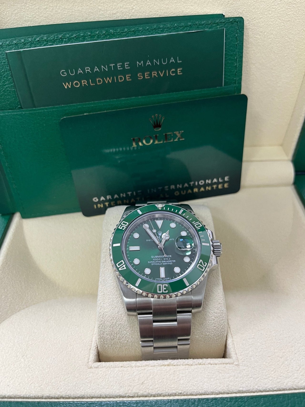 Display of complete Rolex Submariner Hulk 116610LV full set including box, card, and booklet – like-new 2018 green Submariner available now from Global Sky Diamonds – globalskydiamond.com