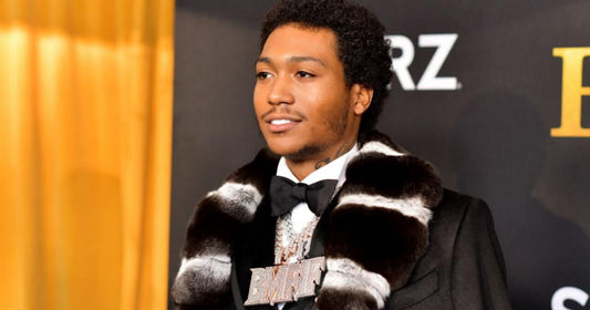 Lil Meech in Miami wearing a custom iced-out Rolex Daytona watch, later tied to a theft arrest involving Haimov Jewelers and a fake trade-in.