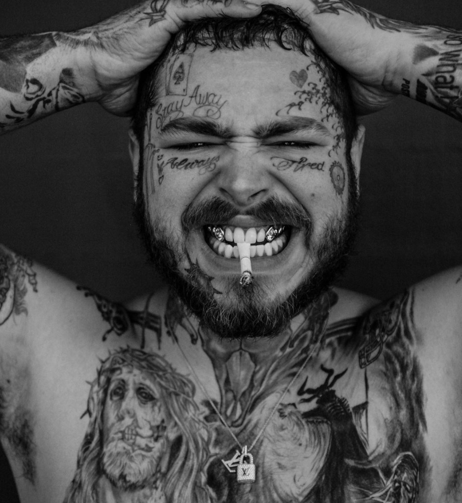 Post Malone smiling with permanent diamond teeth featuring 12 carats of custom-cut diamonds by celebrity dentist Thomas Connelly in Los Angeles.