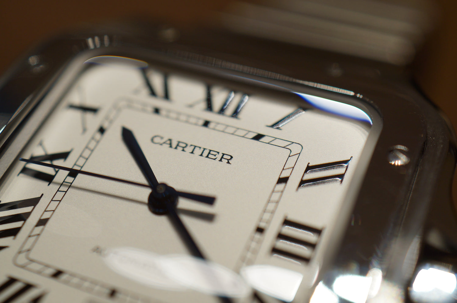 Close-up of Cartier logo on luxury watch dial, showcasing fine Swiss craftsmanship and iconic branding – available at globalskydiamond.com, Global Sky Diamonds in NYC Diamond District.