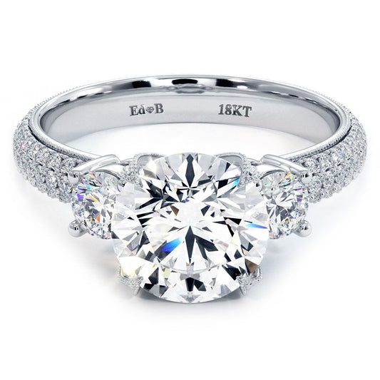 Close-up front view of a round center three-stone diamond engagement ring with micropavé and eagle prongs, crafted in 18k white gold – available at GlobalSkyDiamond.com | @globalskydiamonds | #Mazalito #DiamondDistrict