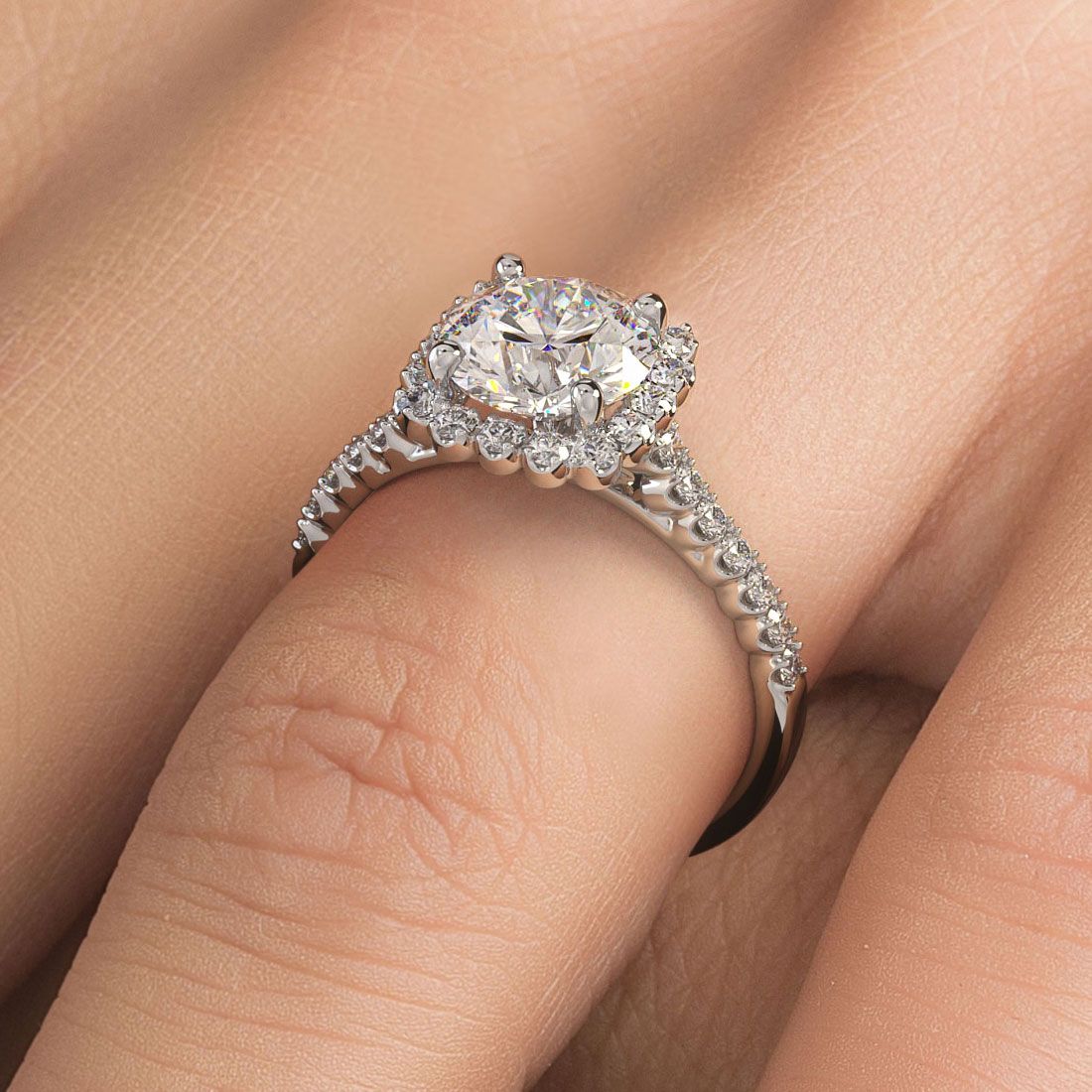 Cushion halo engagement ring with round center diamond shown on hand for scale and sparkle, showcasing 18k white gold setting with 0.50ctw pavé diamonds, from Global Sky Diamonds, Diamond District NYC. Visit GlobalSkyDiamond.com or Instagram @globalskydiamonds.