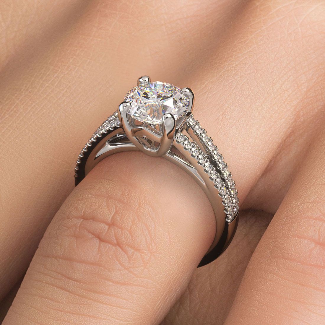 Round brilliant micro-prong diamond engagement ring setting in 18k white gold shown worn on hand, split shank design set with 0.31ctw of G/SI1 round side stones. Crafted to fit a 1.50ct round center stone. Modern, elegant and timeless. From Global Sky Diamonds, located in the heart of the NYC Diamond District at 44W 47th St Booth GF-10. View more at globalskydiamond.com.